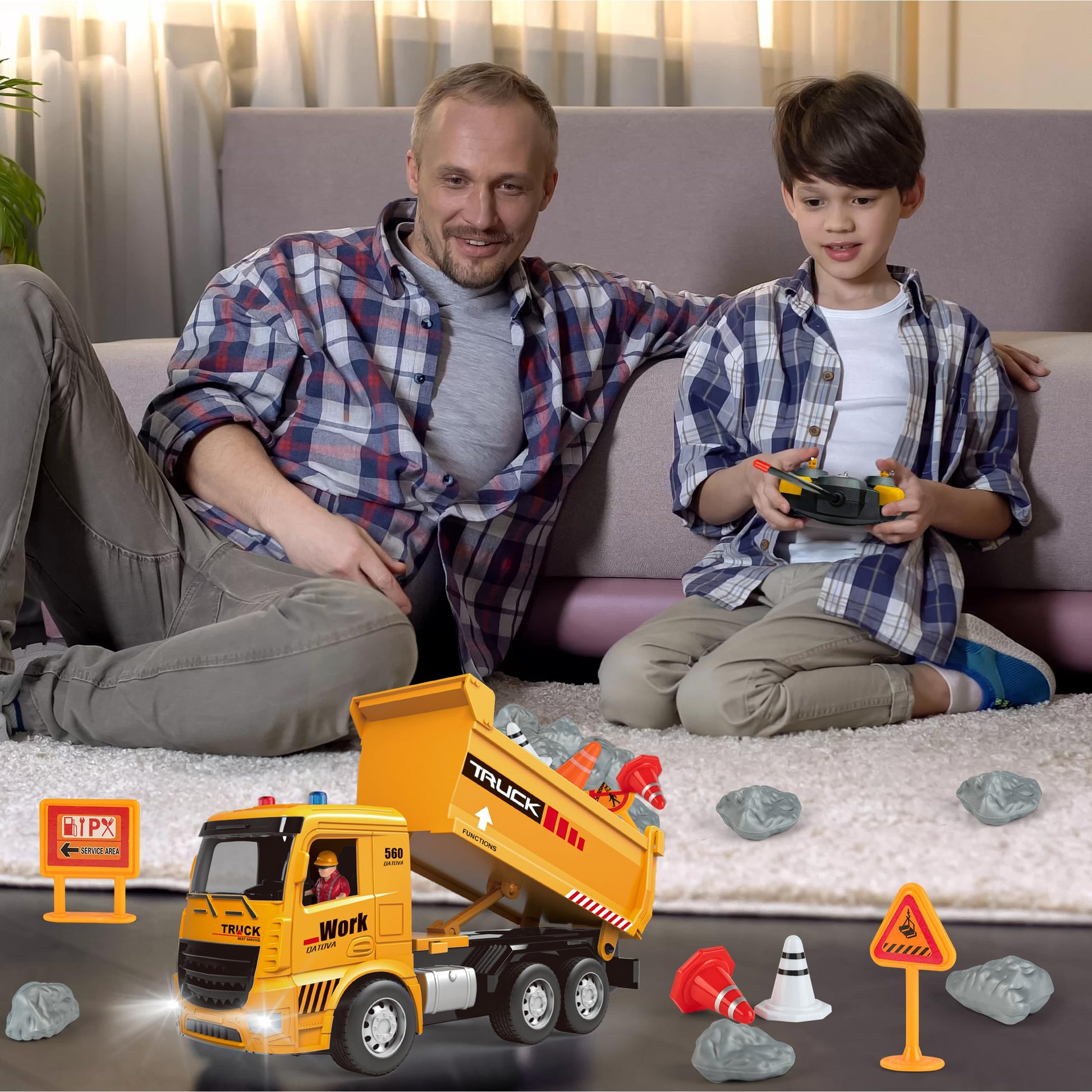 Man and child playing with a toy dump truck on a couch